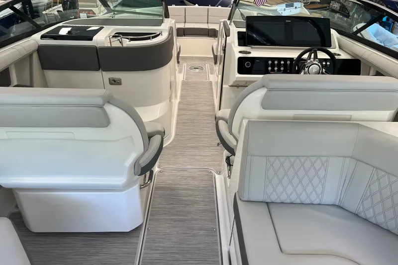 Slide: The Image of 2024 Sea Ray SLX 310 boat interior with luxurious seating and modern dashboard. - 13