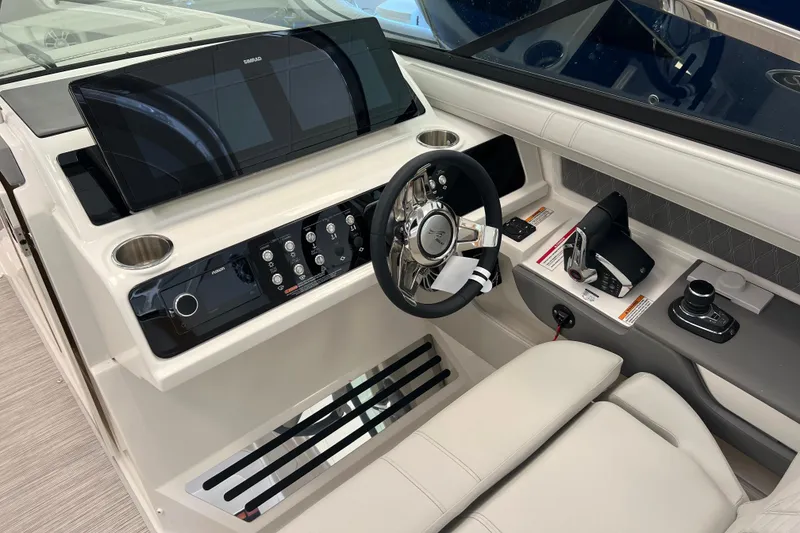 Slide: The Image of 2024 Sea Ray SLX 310 helm with modern controls and sleek design. - 16