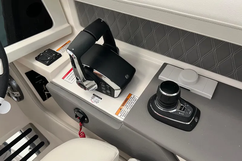Slide: The Image of 2024 Sea Ray SLX 310 helm controls with joystick and throttle. - 18