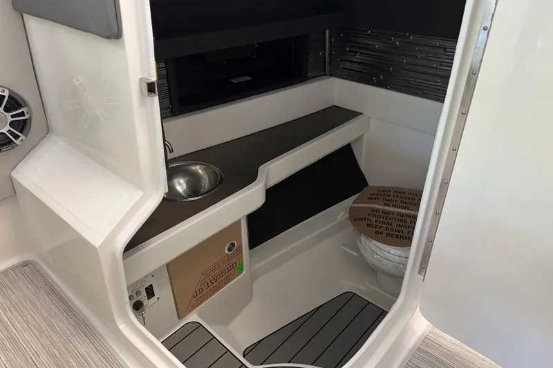 Slide: The Image of 2024 Sea Ray SLX 310 interior cabin with sink and storage area. - 20