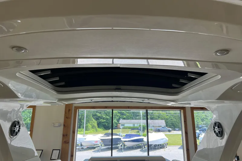 Slide: The Image of 2024 Sea Ray SLX 310 boat interior with sunroof and speakers, showcasing modern design. - 27