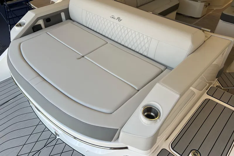 Slide: The Image of 2024 Sea Ray SLX 310 boat with luxurious seating and cup holders on deck. - 3