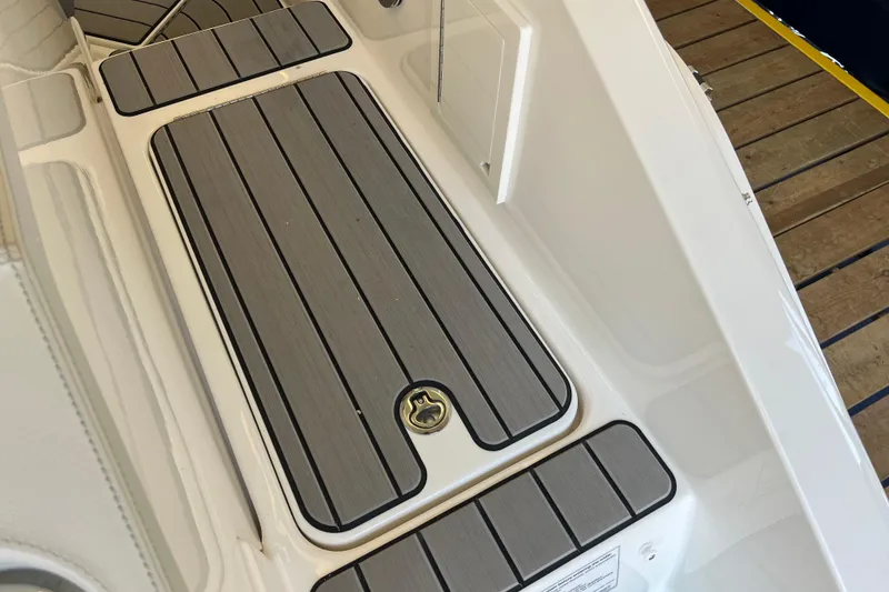 Slide: The Image of 2024 Sea Ray SLX 310 boat deck with sleek, modern design and wood-like finish. - 4