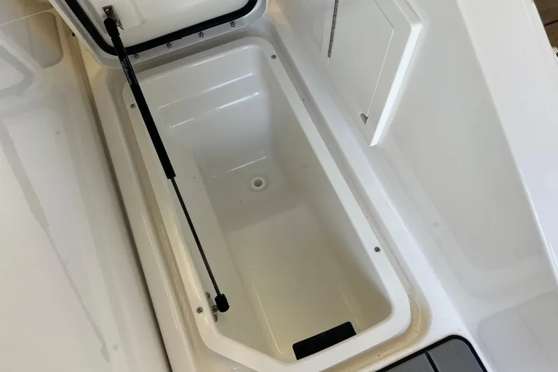Slide: The Image of Storage compartment of 2024 Sea Ray SLX 310 boat, open and empty. - 5