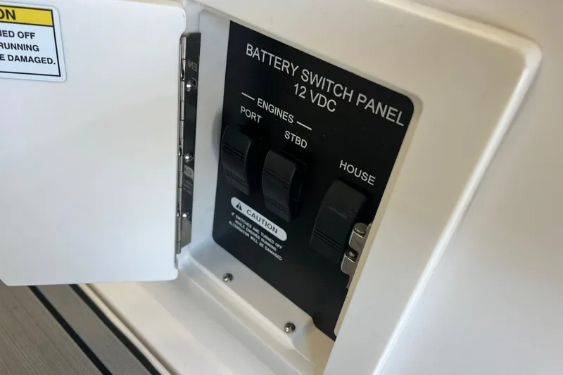 Slide: The Image of Battery switch panel on 2024 Sea Ray SLX 310 boat, showing engine and house controls. - 6