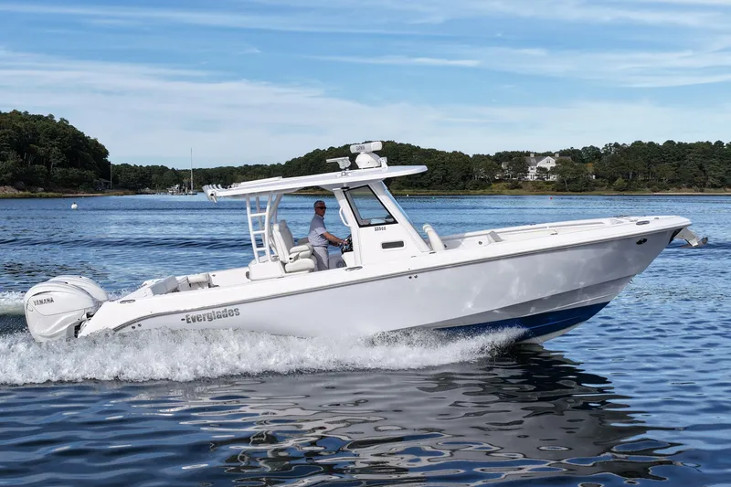 The Image of 2020 Everglades 335 Center Console boat cruising on a scenic lake. - 0
