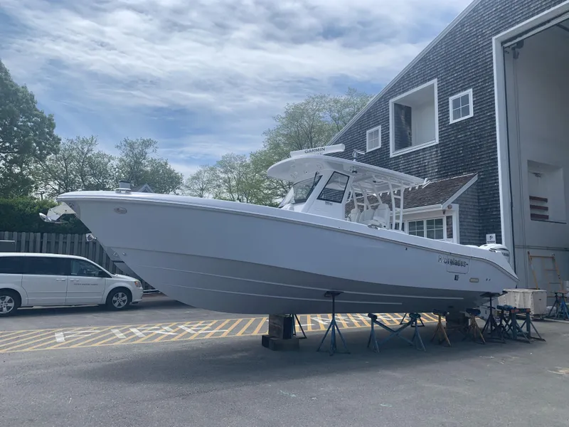 Slide: The Image of 2020 Everglades 335 Center Console boat on stands outside a building. - 17