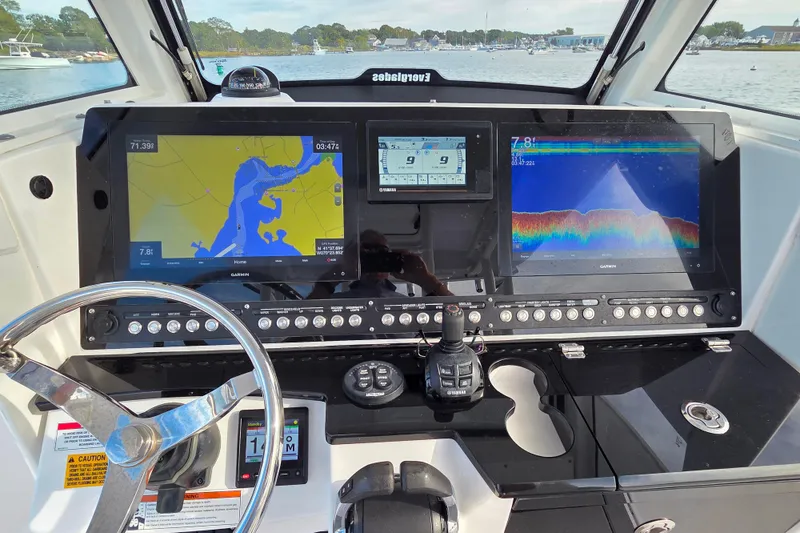 Slide: The Image of 2020 Everglades 335 Center Console dashboard with navigation and sonar displays. - 20