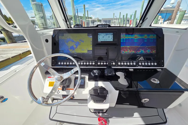 Slide: The Image of 2020 Everglades 335 Center Console dashboard with advanced navigation and control systems. - 21
