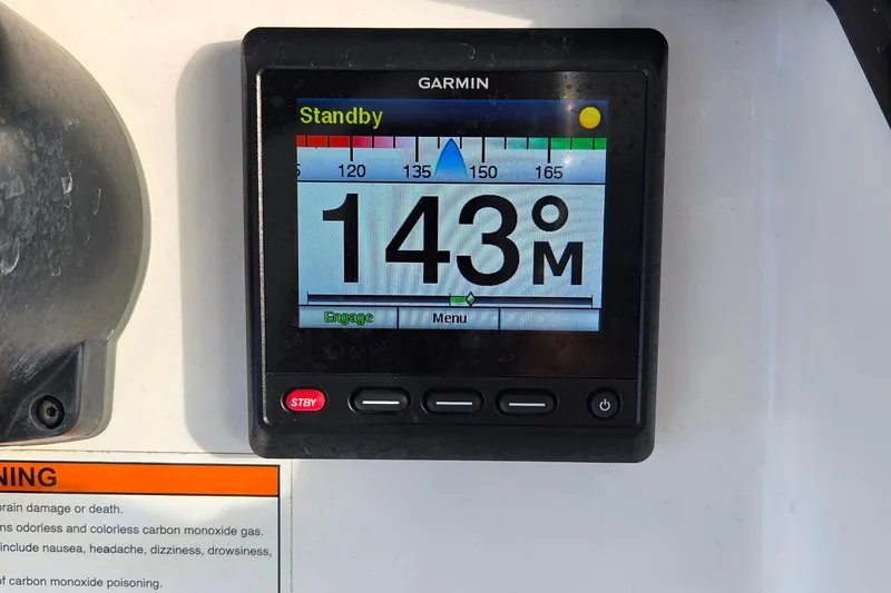 Slide: The Image of Garmin display on 2020 Everglades 335 Center Console showing 143 meters in standby mode. - 22