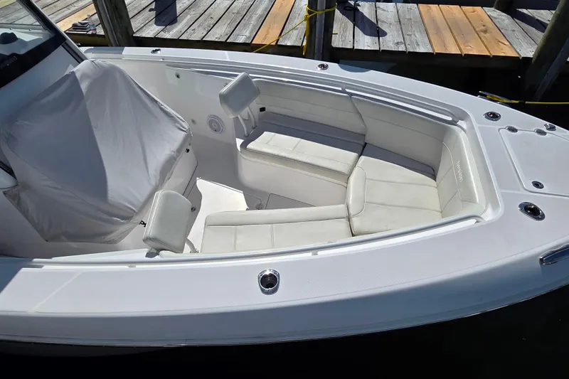 Slide: The Image of 2020 Everglades 335 Center Console boat with white cushioned seating at dock. - 27