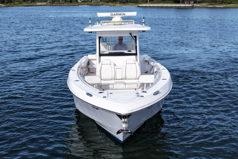Slide: The Image of 2020 Everglades 335 Center Console boat on calm water, front view. - 3
