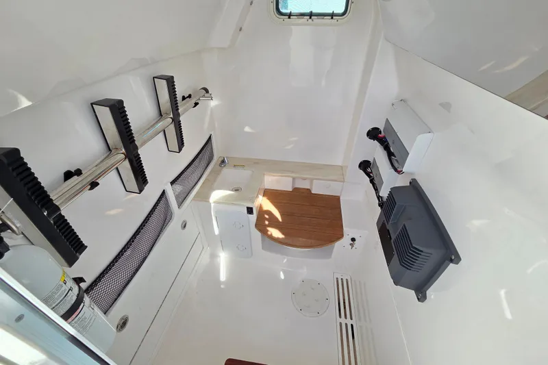 Slide: The Image of 2020 Everglades 335 Center Console interior cabin with storage and seating. - 31