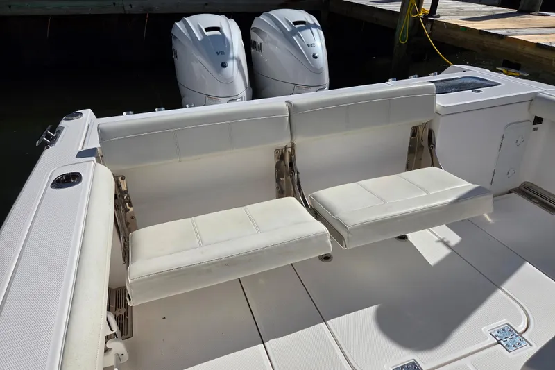 Slide: The Image of 2020 Everglades 335 Center Console boat with dual Yamaha engines and white seating. - 32