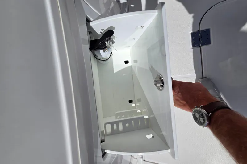 Slide: The Image of Open storage compartment on 2020 Everglades 335 Center Console boat. - 34