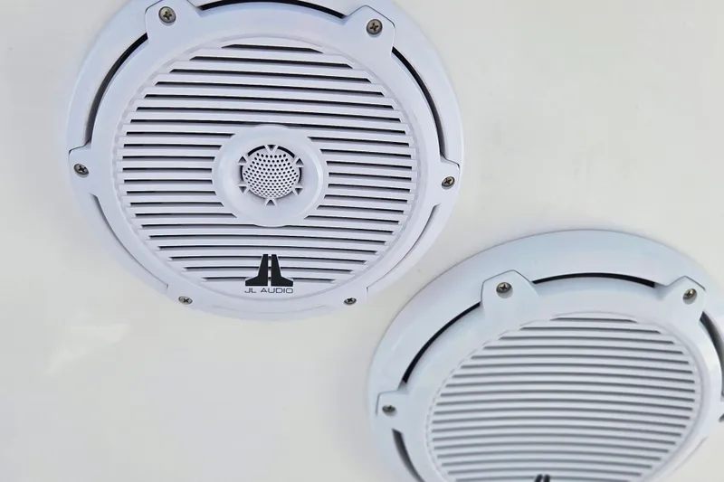 Slide: The Image of White JL Audio speakers on a 2020 Everglades 335 Center Console boat. - 38