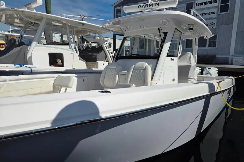 Slide: The Image of 2020 Everglades 335 Center Console boat docked, featuring sleek design and modern equipment. - 39