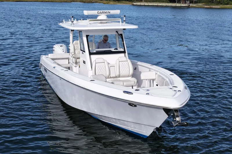 Slide: The Image of 2020 Everglades 335 Center Console boat on water, featuring sleek design and advanced navigation. - 4