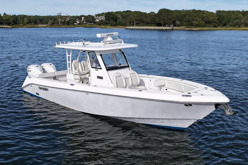 Slide: The Image of 2020 Everglades 335 Center Console boat on calm water, featuring twin engines. - 5