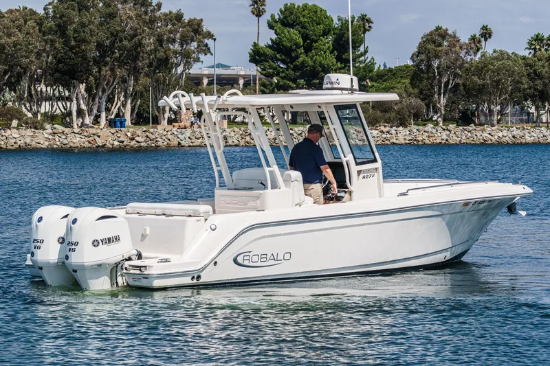 Slide: The Image of 2020 Robalo R272 Center Console boat on water, featuring twin Yamaha engines. - 1