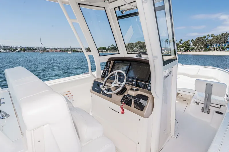 Slide: The Image of 2020 Robalo R272 Center Console boat interior with steering wheel and controls. - 17