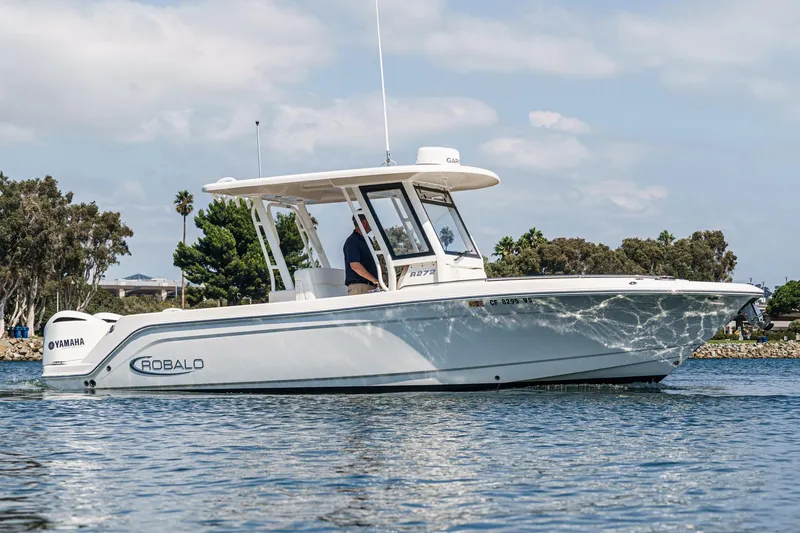 Slide: The Image of 2020 Robalo R272 Center Console boat cruising on a sunny day. - 2