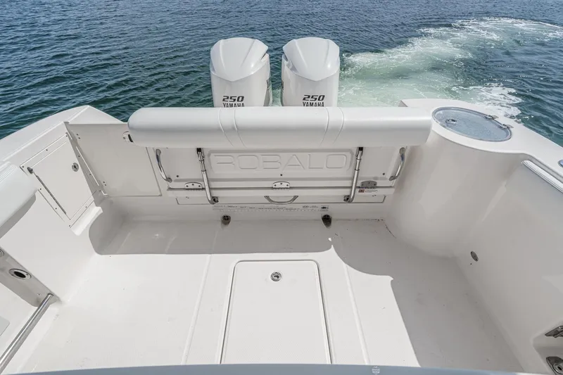Slide: The Image of 2020 Robalo R272 Center Console boat with twin Yamaha 250 engines on open water. - 22