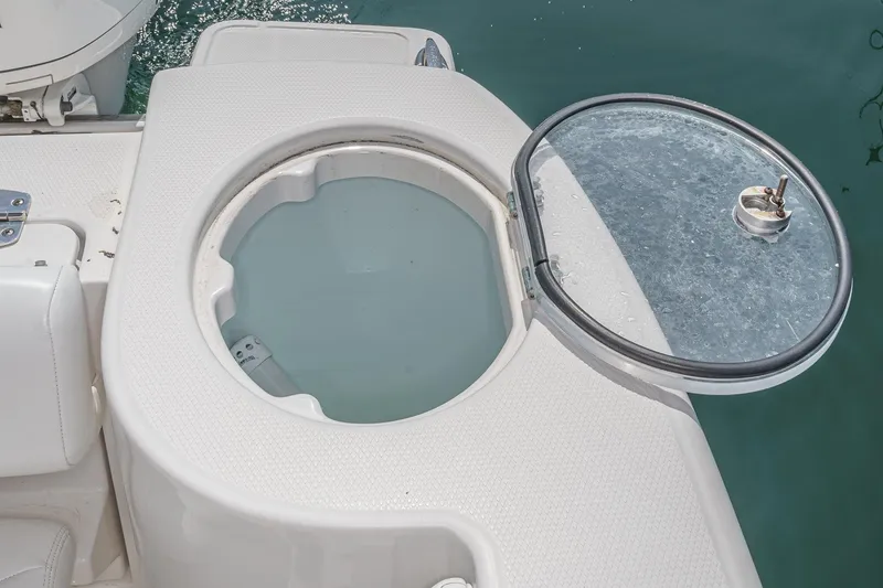 Slide: The Image of 2020 Robalo R272 Center Console livewell with open lid, showing interior details. - 25