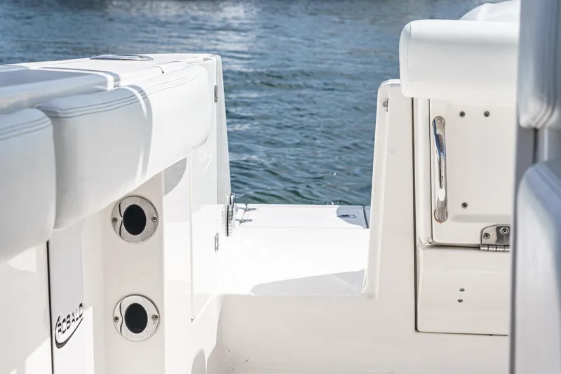 Slide: The Image of 2020 Robalo R272 Center Console boat interior with white seating and water view. - 28