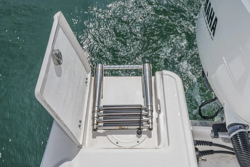 Slide: The Image of 2020 Robalo R272 Center Console boat with folded swim ladder and open hatch. - 29