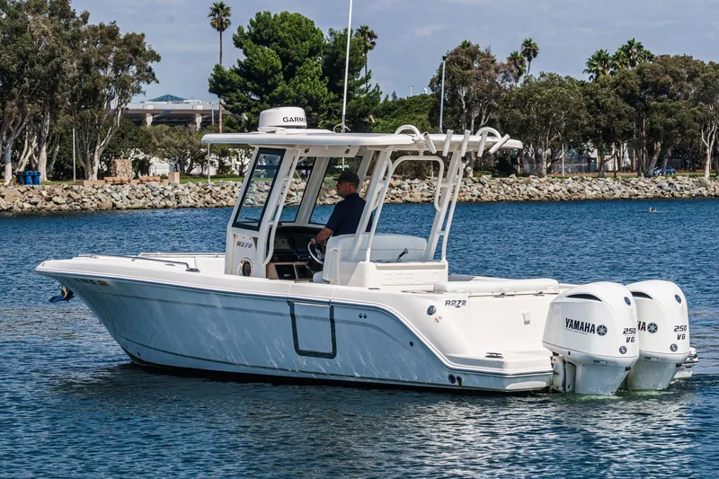Slide: The Image of 2020 Robalo R272 Center Console boat on water with twin Yamaha engines. - 3