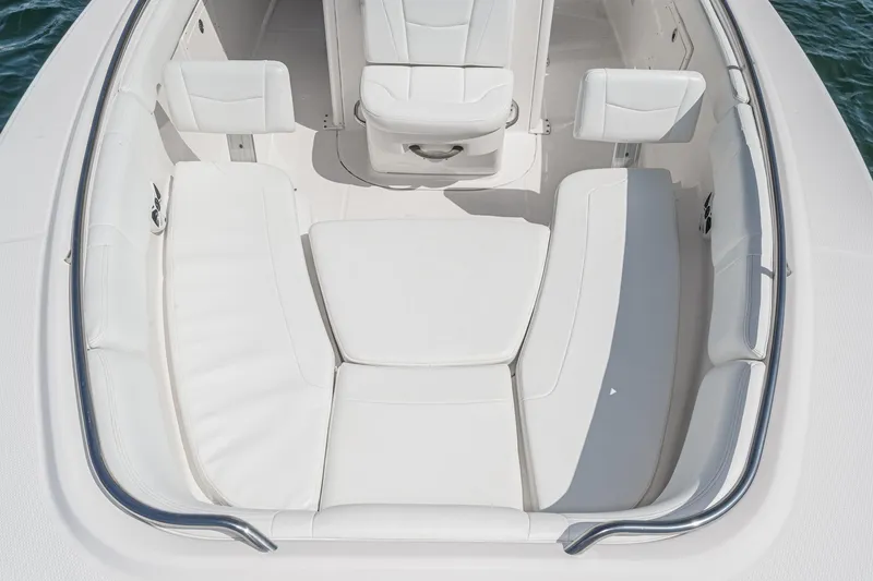 Slide: The Image of 2020 Robalo R272 Center Console boat with white cushioned seating. - 30