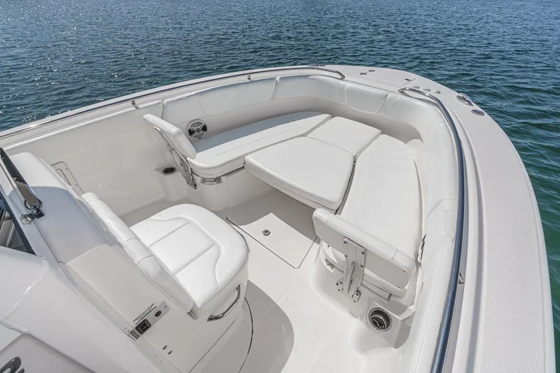 Slide: The Image of 2020 Robalo R272 Center Console boat interior with white seating on water. - 31