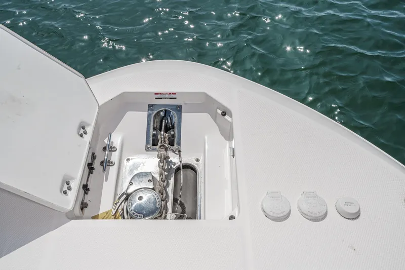 Slide: The Image of 2020 Robalo R272 Center Console anchor locker with open hatch on calm water. - 33