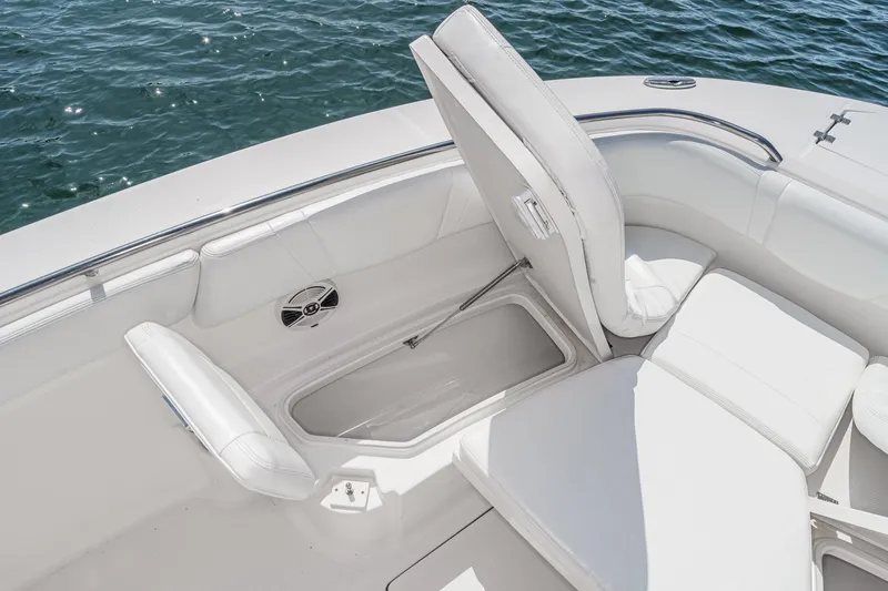 Slide: The Image of 2020 Robalo R272 Center Console boat with open storage compartment and white seating. - 35
