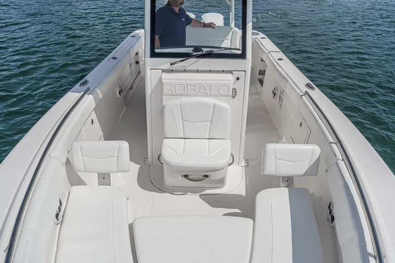 Slide: The Image of 2020 Robalo R272 Center Console boat interior with seating, on calm water. - 36