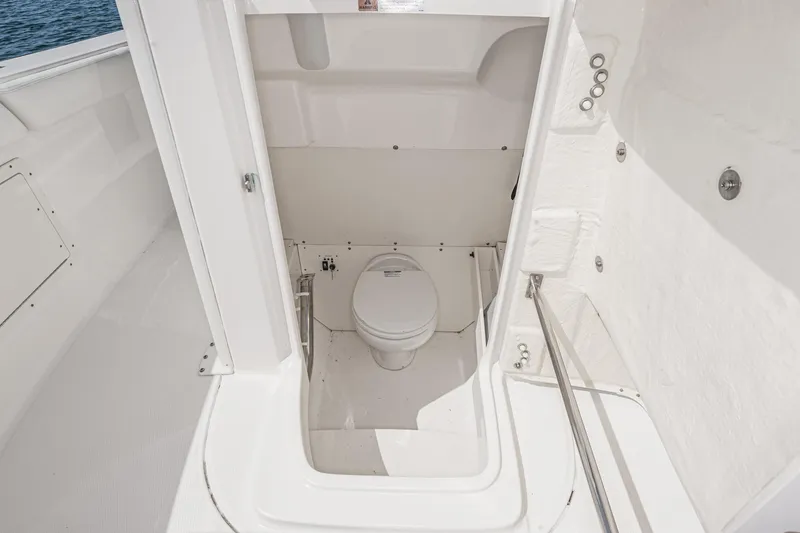 Slide: The Image of 2020 Robalo R272 Center Console boat interior with compact marine toilet. - 38