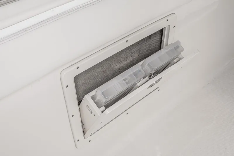 Slide: The Image of 2020 Robalo R272 Center Console storage compartment with tackle boxes. - 39