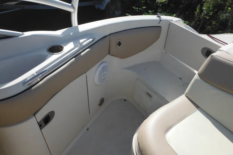 Slide: The Image of 2005 Sea Ray 220 Sundeck interior with beige seating and storage compartments. - 10