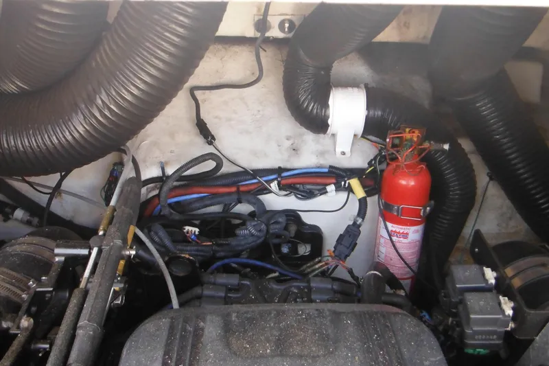 Slide: The Image of Engine compartment of a 2005 Sea Ray 220 Sundeck with fire extinguisher and wiring. - 12