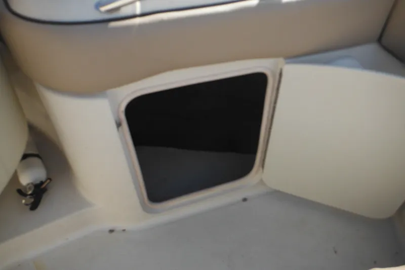 Slide: The Image of Open storage compartment on a 2005 Sea Ray 220 Sundeck boat interior. - 14