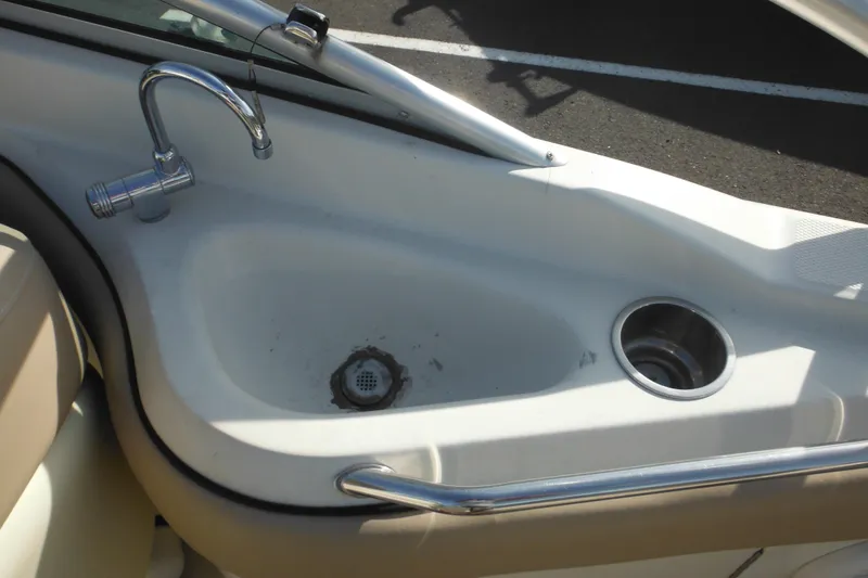 Slide: The Image of 2005 Sea Ray 220 Sundeck boat sink with faucet and cup holder. - 15