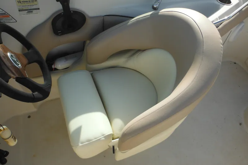 Slide: The Image of Captain's seat and steering wheel of 2005 Sea Ray 220 Sundeck boat. - 16
