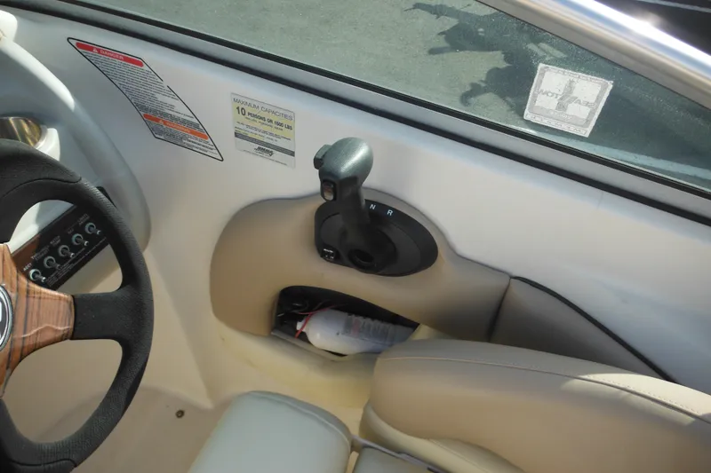Slide: The Image of Interior view of a 2005 Sea Ray 220 Sundeck boat cockpit with steering wheel and controls. - 17