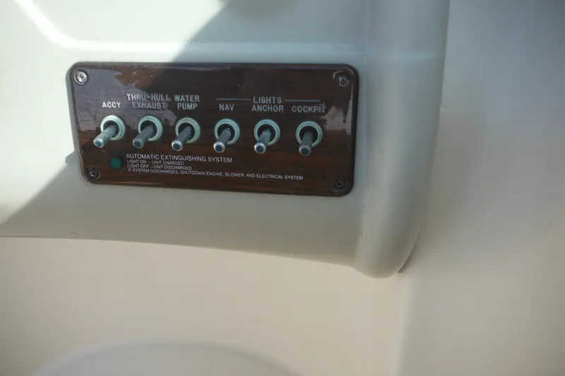 Slide: The Image of Control panel of a 2005 Sea Ray 220 Sundeck boat with labeled switches. - 20