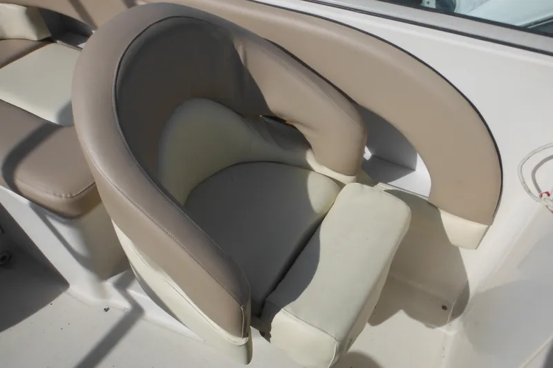 Slide: The Image of 2005 Sea Ray 220 Sundeck boat seat with beige and cream upholstery. - 23