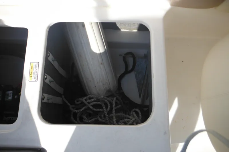 Slide: The Image of Storage compartment of 2005 Sea Ray 220 Sundeck with ropes and equipment. - 27