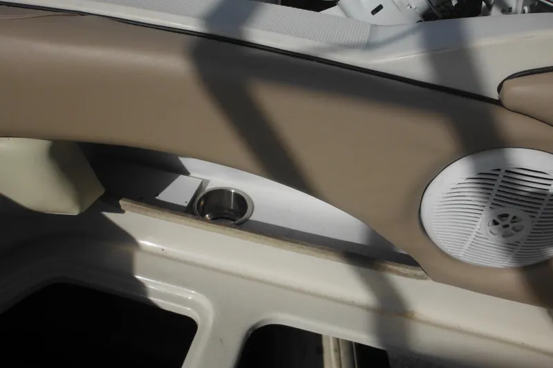 Slide: The Image of 2005 Sea Ray 220 Sundeck interior with speaker and cup holder. - 28