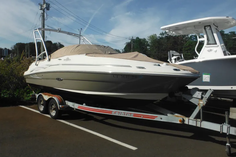 Slide: The Image of 2005 Sea Ray 220 Sundeck boat on trailer, parked outdoors. - 3