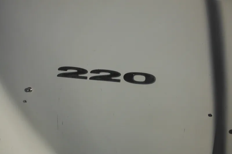 Slide: The Image of Close-up of 2005 Sea Ray 220 Sundeck model number on boat hull. - 31